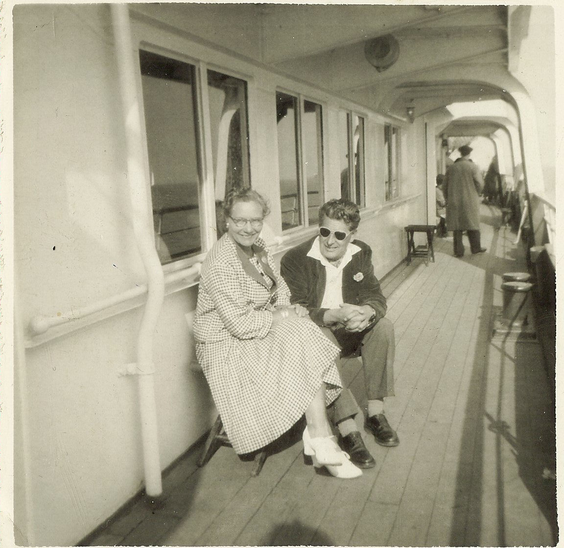 John and Georgina on a pier or a boat.