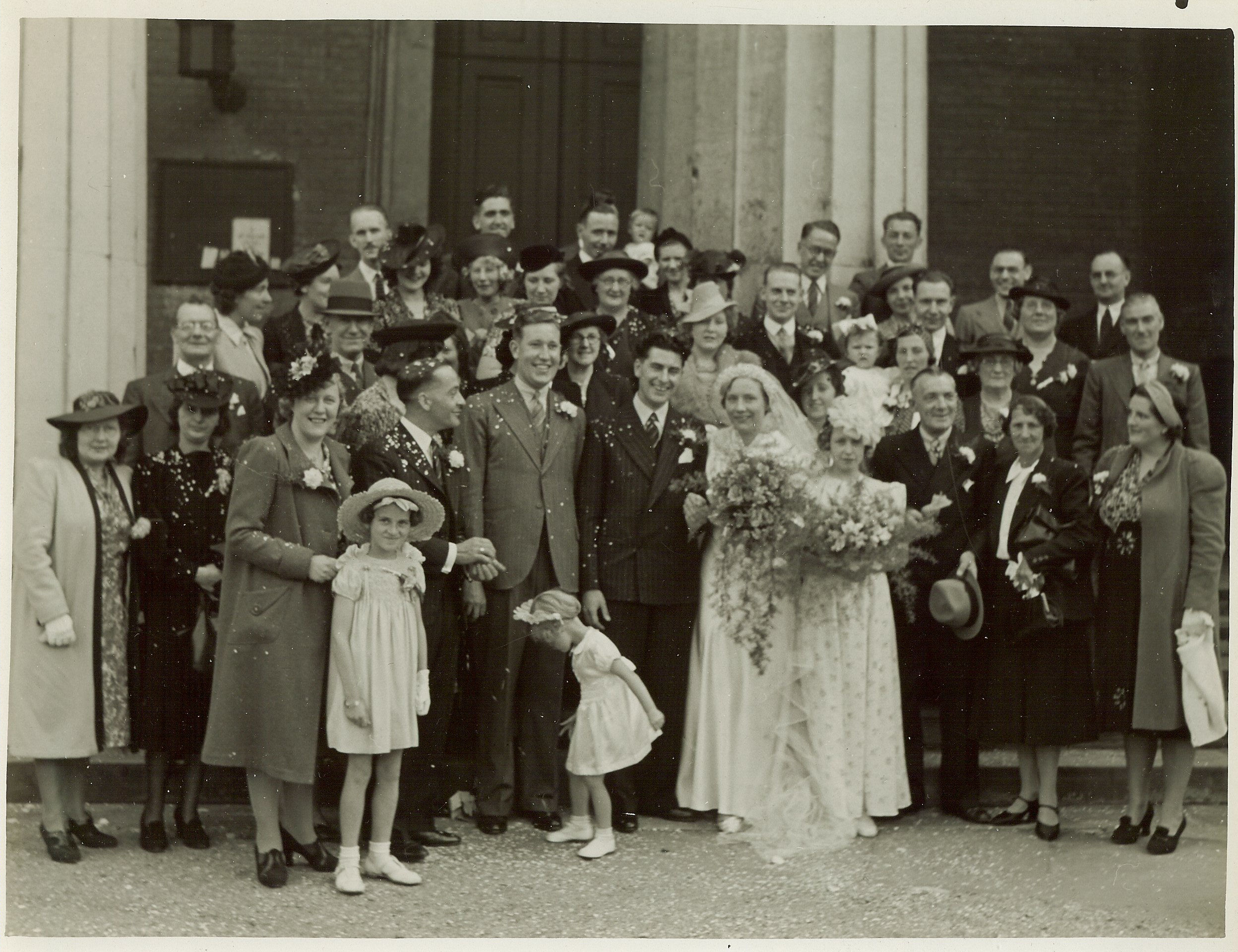 A wedding photo of John and Georgina with their guests.