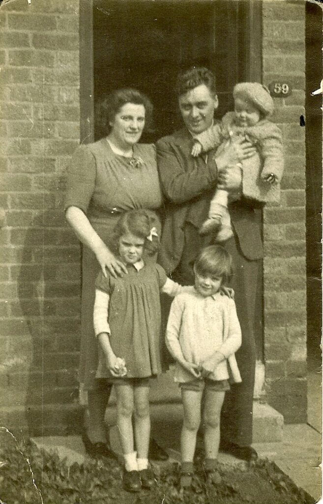 The Riley family pose on the doorstep.