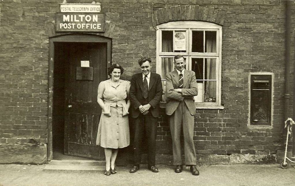 Len and his wife standing outside their post office in Milton